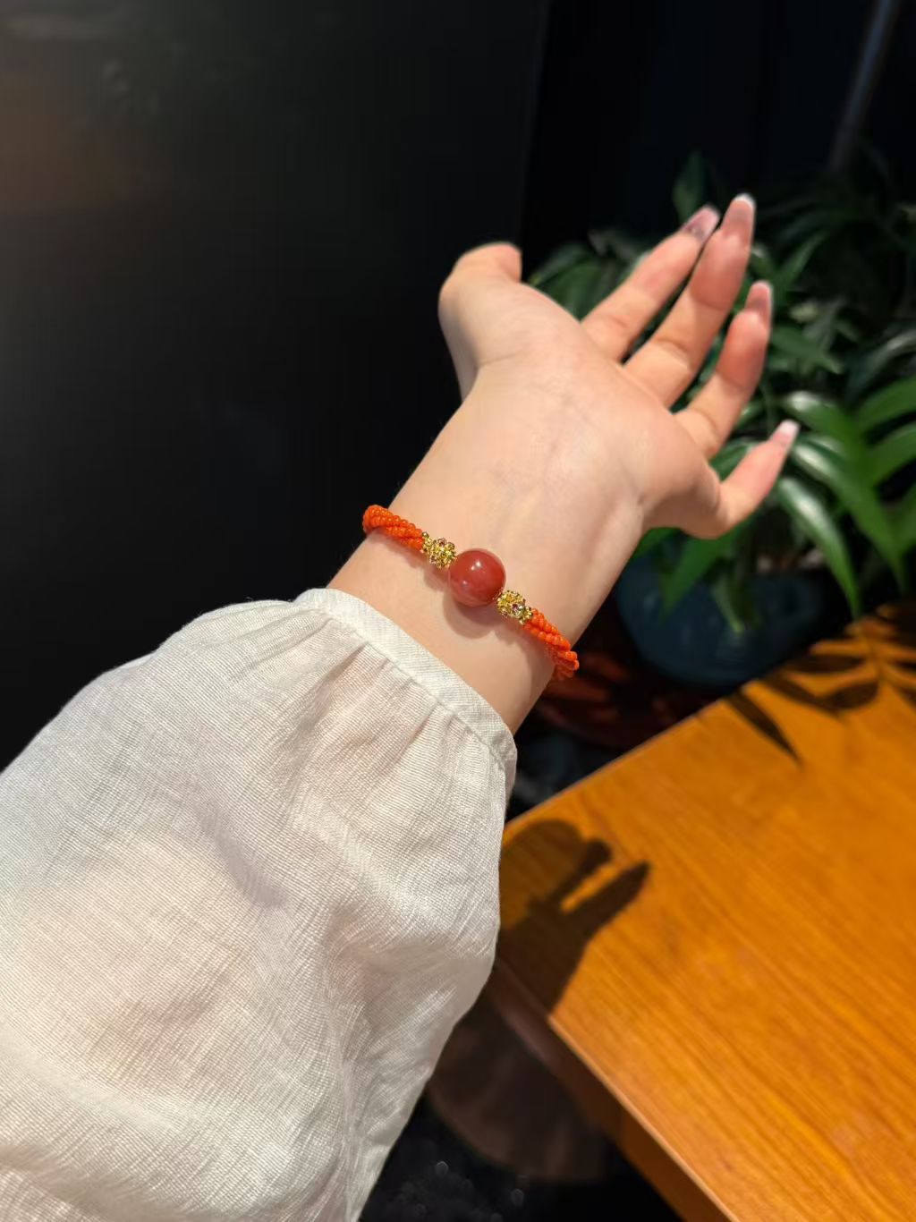 Carnelian bracelet worn on wrist Tae Shine confidence