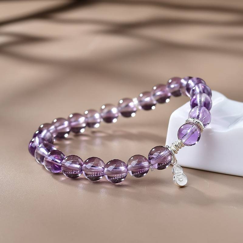 Amethyst crystal bracelet with a hulu (gourd) charm for good fortune and intuition.